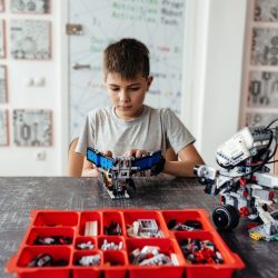Boy with controlled robot by tablet computer and Joystick.